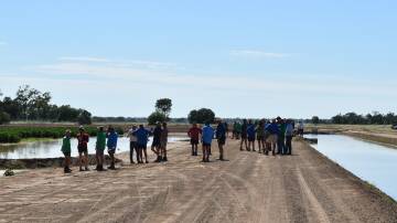 Cotton growers at a field day held in the Macquarie Valley investigate a new pontoon irrigation set-up. Picture by Lou Gall